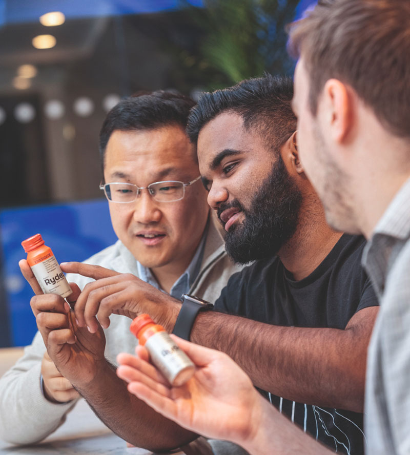 3 men looking at a package