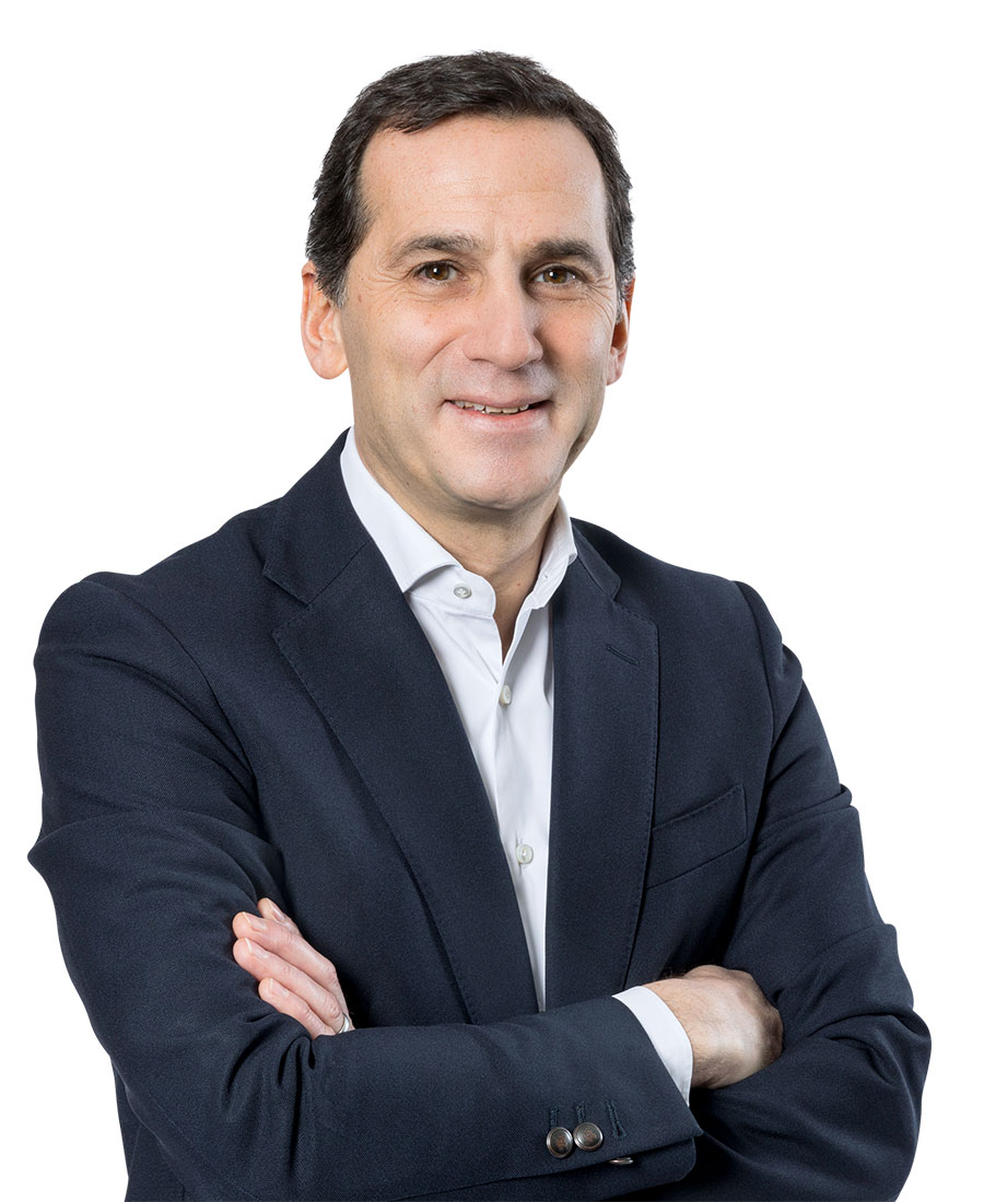 Donato wearing a suit smiling for the camera